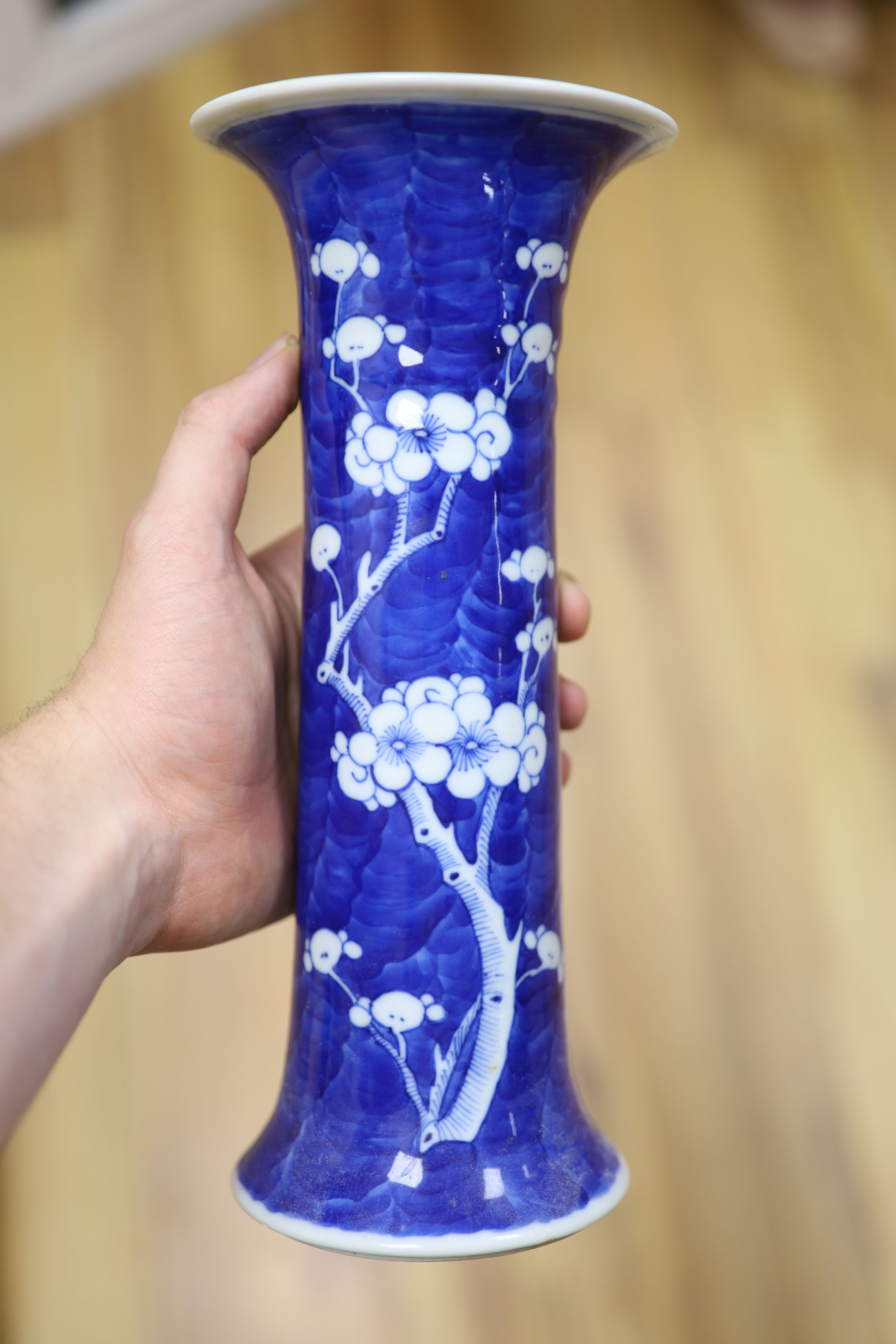 Two Chinese blue and white prunus pattern ginger jars and a similar cylinder vase, tallest 26cm